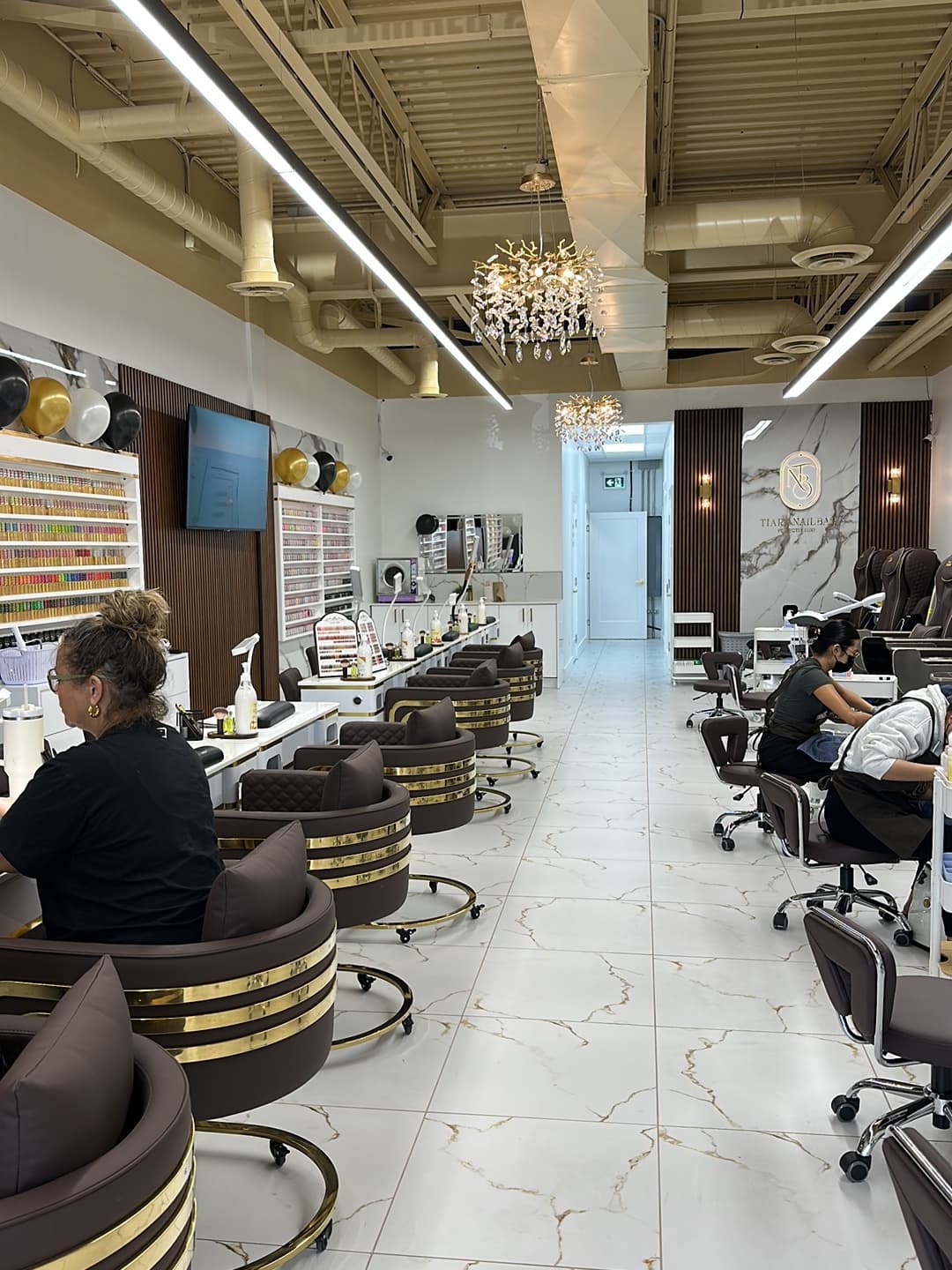 Inside Tiara Nail Bar — marble manicure stations and crystal chandeliers